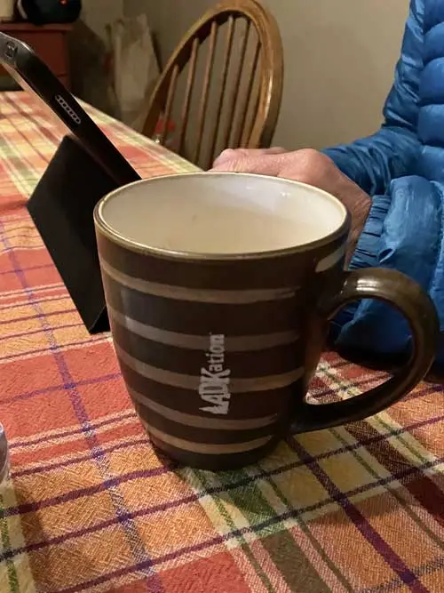 Striped coffee mug with ADKation™ laser engraved vertically. A fun and unique Adirondack vacation souvenir.
