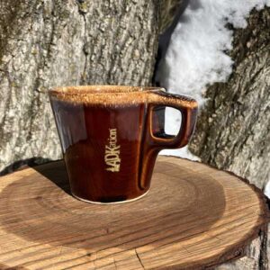 A classic, dipped style mug with the text ‘ADKation” engraved vertically near the handle, keeping thoughts of Adirondack vacation experiences within sight. A unique and limited quantity ADK vacation gift, offering a more engaging connection to time shared in the ADK.